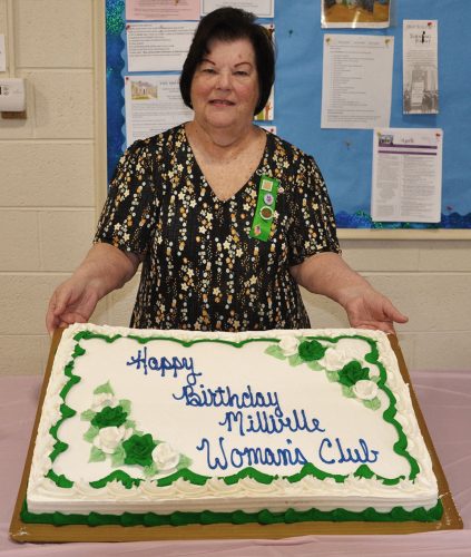 Joan Fauver, MWC president, shows off birthday cake.