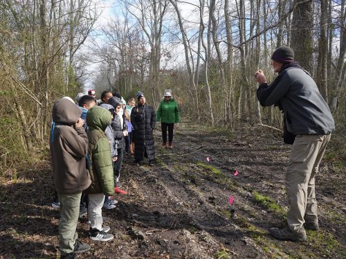 Teacher and CU volunteer Peter Manzelmann discusses flagged animal tracks along the nature trail.  Photo: Sue Godfrey