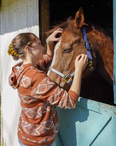 Amelia Holmes is pictured with her equine friend Rip, who helps many with health and wellness therapies at Hit the Stars Learning with Horses, located in Leesburg.