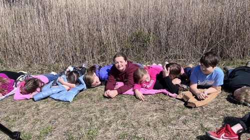 Unprompted, students decided to lie down while waiting their turn to look through telescopes. They were simply enjoying the outdoors and the sunny day. Photo: J. Morton Galetto 